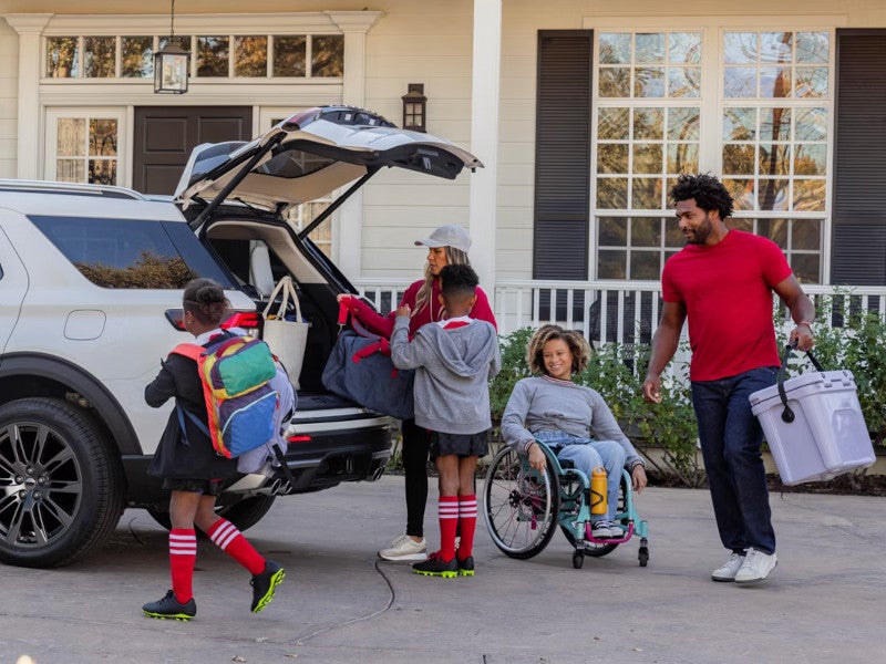 Family loading the White SUV